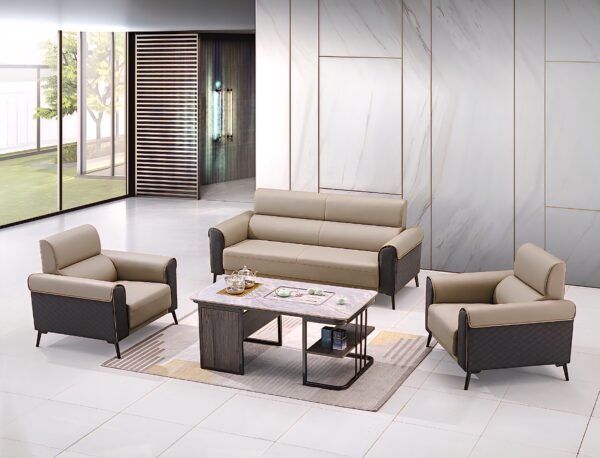 A modern, five-seater sofa set with light beige leather upholstery and dark grey patterned accents, comprising a three-seater sofa and two matching single-seater armchairs, arranged around a contemporary wooden and metal coffee table on a light rug in a spacious, minimalist room.