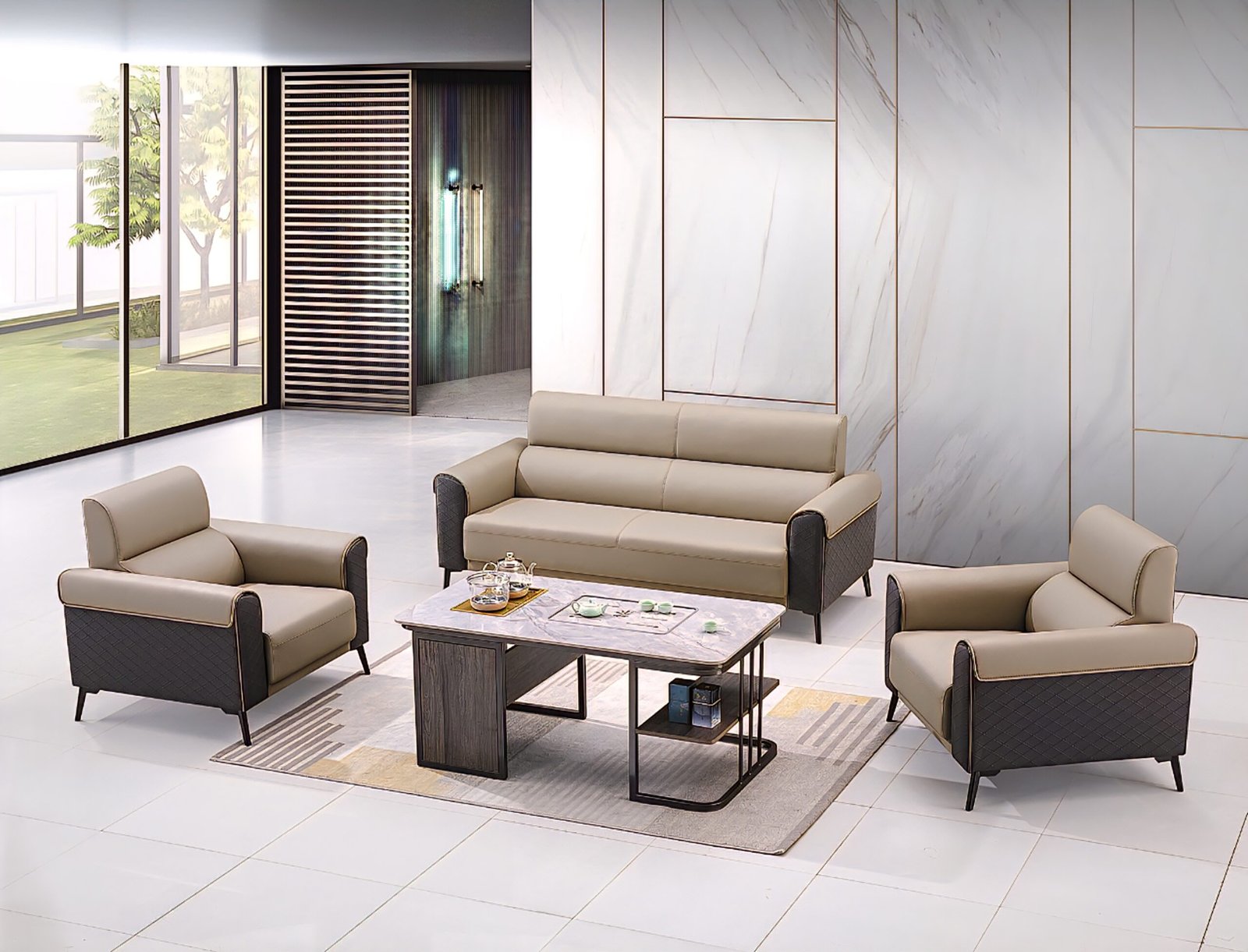 A modern, five-seater sofa set with light beige leather upholstery and dark grey patterned accents, comprising a three-seater sofa and two matching single-seater armchairs, arranged around a contemporary wooden and metal coffee table on a light rug in a spacious, minimalist room.